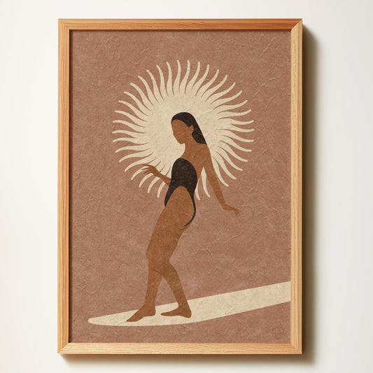 Framed artwork of a woman on a surfboard with a sunburst design on a brown background