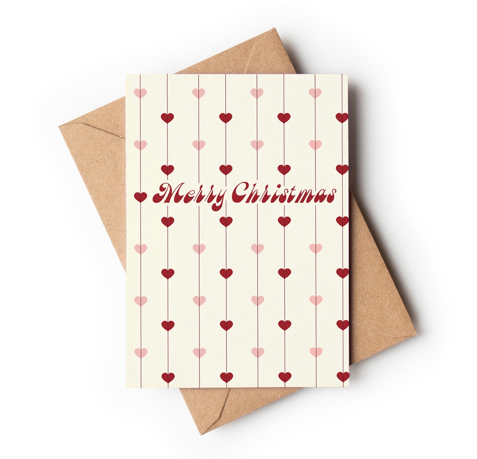 Christmas card with heart patterns and 'Merry Christmas' text, accompanied by a brown envelope on a white background.