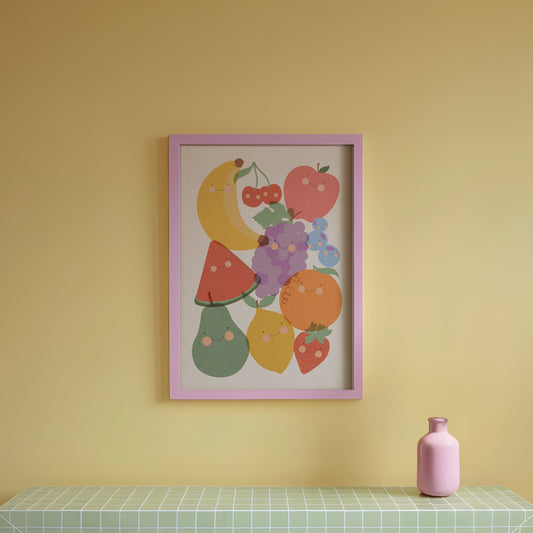 Green tiled table with a pink vase against a yellow wall with a colorful fruit print.